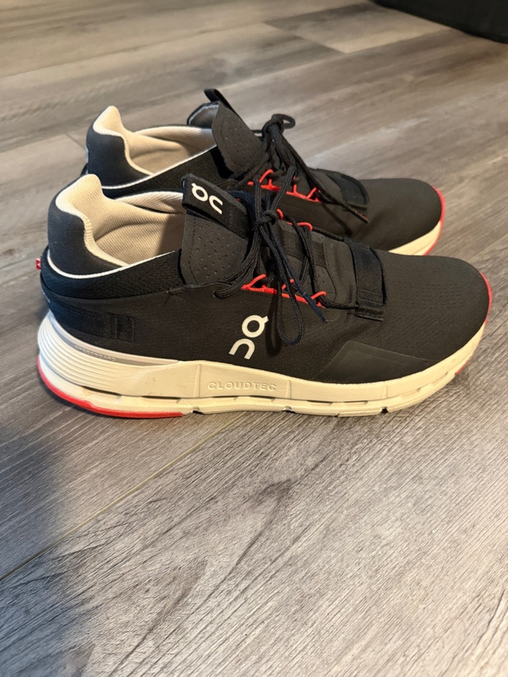 On Running Men’s Black Sneakers with White Midsole and Red Accents